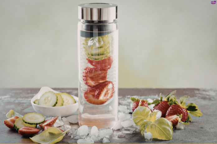 Infused fruit water with lemon, cucumber, and strawberries for hydration during pregnancy in summer