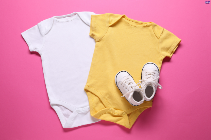 Newborn clothes: A white and yellow onesie for babies, paired with tiny shoes, offering comfort and style.