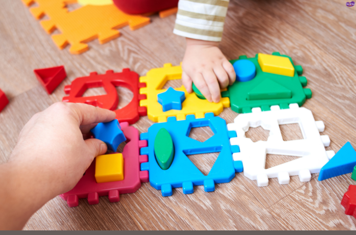 Toddler matching colorful shapes in a shape sorter, brain-boosting toys for children that develop hand-eye coordination.
