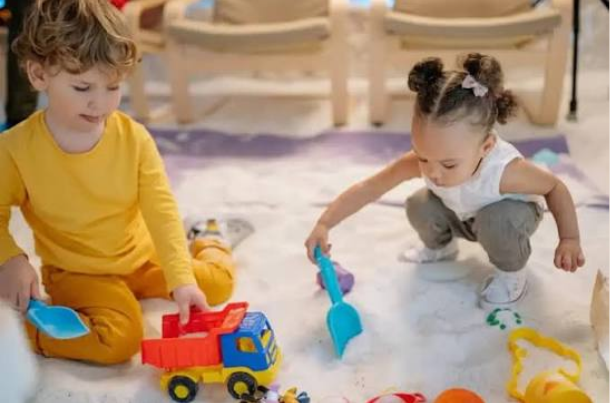 when do babies play with other babies