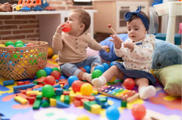 when do babies reach for toys
