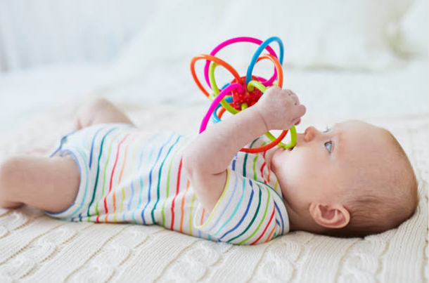 when do babies reach for toys